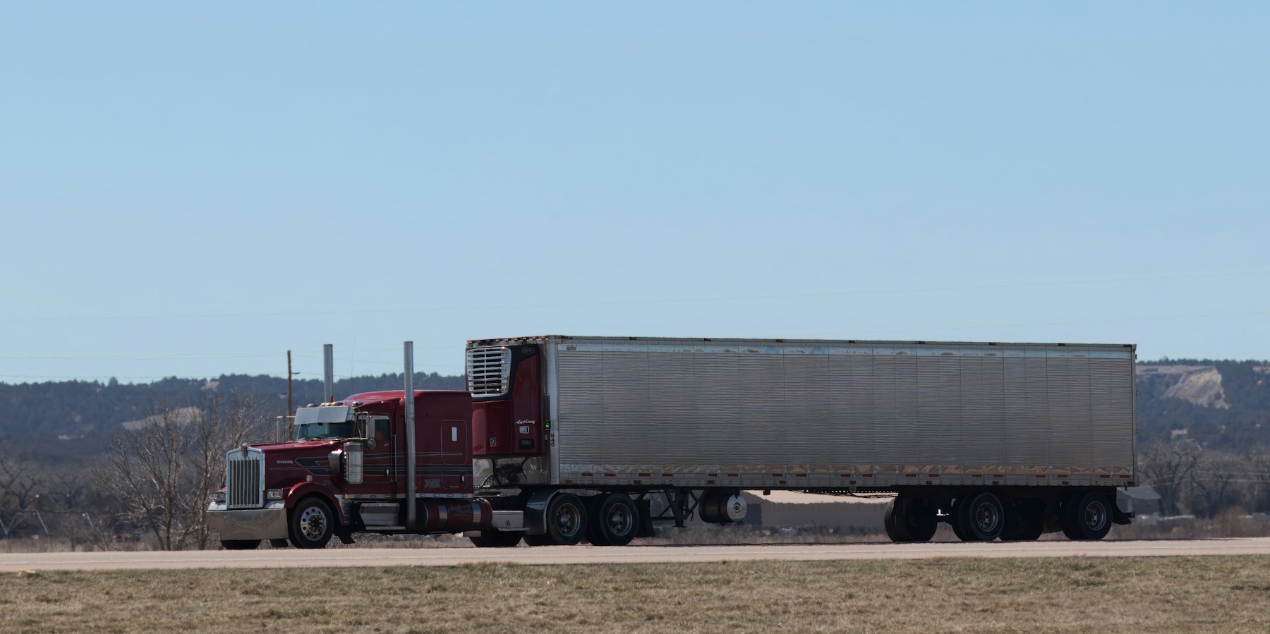 Refrigerated tractor-trailer on a highway